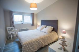a bedroom with a bed and a window at Cap Canche in Étaples