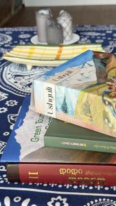 three books sitting on top of a table at IparAlto in Mestia