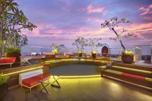 a rooftop patio with a pool on top of a building at ibis Styles Yogyakarta in Yogyakarta