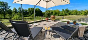 a patio with chairs and an umbrella at Monte Symphony in Rakovica