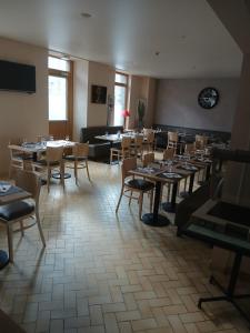a dining room filled with tables and chairs at LE RELAIS DU mene in Le Gouray