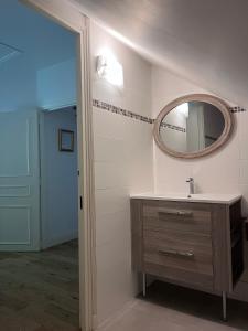 a bathroom with a sink and a mirror at Le Clos du Cerf in Cellettes