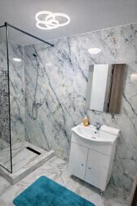 a bathroom with a sink and a shower at Le Charme Boutique in Bucharest