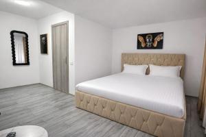 a bedroom with a large bed in a room at Le Charme Boutique in Bucharest +5 photos
