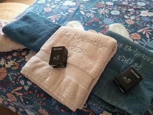 a close up of two towels on a bed at La Belgastide chambre d'hôte in Quins +10 photos