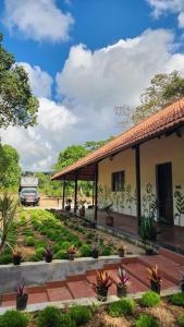 a house with a car parked in front of it at Fiddlehead Fern in Kurchi