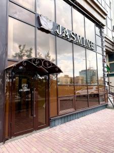 an entrance to a luxury store with a sign on it at Djasmines Hotel Astana in Astana