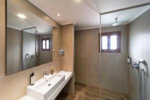 a bathroom with a sink and a glass shower at Lindos Del Mar Suites - Adults Only in Lindos +7 photos