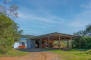 a house with a glass roof on a dirt road at Gardenview Sedgefield in Sedgefield