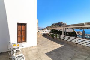 a balcony of a house with a view of the ocean at Lindos Del Mar Suites - Adults Only in Lindos