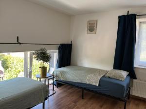 a bedroom with two beds and a window at The 8th in Léglise