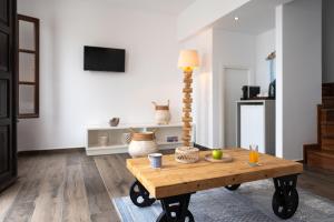 a living room with a coffee table and a lamp at Lindos Del Mar Suites - Adults Only in Lindos