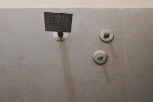 a stone wall with a soap dispenser on it at Srivari Lodge in Arcot