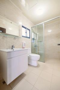 a bathroom with a toilet and a sink and a shower at 澎湖青翠民宿 in Magong +24 photos
