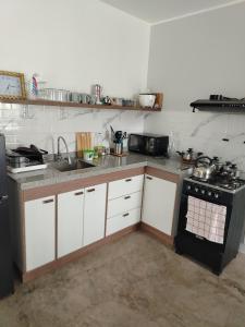 a kitchen with a sink and a stove in it at Casa Reyna in Hacienda Cienguilla