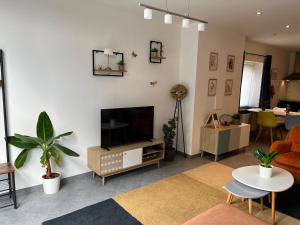 a living room with a flat screen tv on a wall at The 8th in Léglise