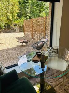 a glass table in a living room with a view of a patio at Between hills and home in Trooz +26 photos