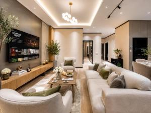 a living room with couches and a tv at 7 Star Apartments in Tashkent