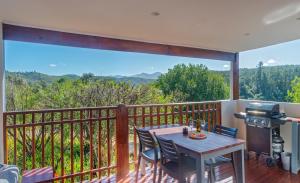 a patio with a table and chairs on a balcony at Mountainview Sedgefield in Sedgefield