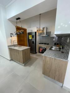 a kitchen with marble counter tops and stainless steel appliances at Furnished two-bedroom apartment DN in Solorín