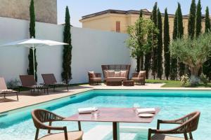 a patio with a table and chairs next to a pool at Antum Hotel in Benevento