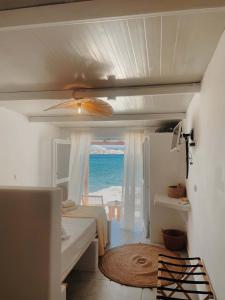 a bedroom with a bed and a view of the ocean at Zacharias Seaside Studio Kimolos in Kimolos