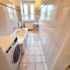a bathroom with a washing machine and a sink at Spacious Flat with 3 bedooms for 5-8 guests in Zeitz +48 photos
