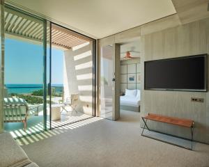 a living room with a flat screen tv on a wall at Voyage Kundu in Antalya