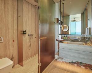 a bathroom with a shower and a toilet and a sink at Voyage Kundu in Antalya +33 photos