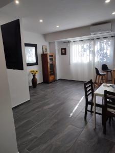 a living room with a table and chairs and a room with white walls at Apartamento Centro in Rubí
