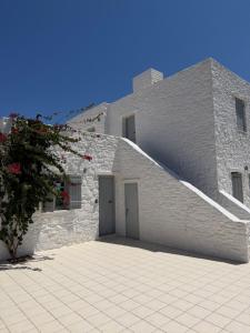 a stone building with a staircase in front of it at LA MAISON D'HELENE in Naousa