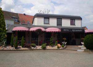 a building with pink awnings on the front of it at Hotel Ruble in Homburg
