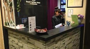 a woman standing at a counter in a store at ST Signature Bugis Beach in Singapore