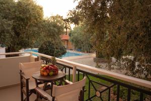 a table with a bowl of fruit on a balcony at vranas hotel in Skala Sotiros