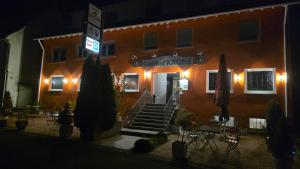 an orange building with a sign on the front of it at Gasthof Krone in Adelberg