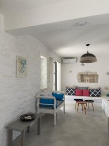 a living room with a couch and a table at LA MAISON D'HELENE in Naousa +25 photos