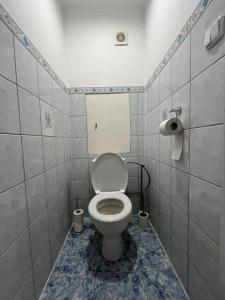 a bathroom with a toilet in a tiled room at BardiHome in Bardejov +10 photos