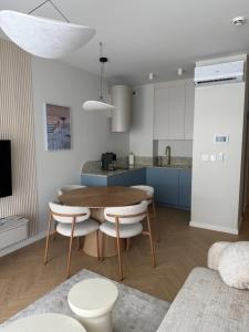 a kitchen with a table and chairs in a room at Apartament Lake Mood Iława in Iława