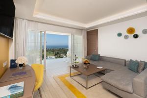 a living room with a couch and a table at The View Bouznika in Bouznika