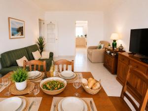 a living room with a table with food on it at Apartamento Oásis Parque 3 in Portimão