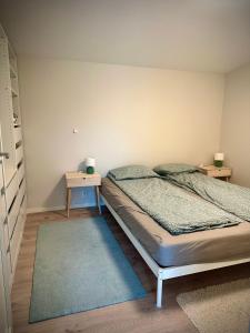 a bedroom with a bed and a table with two lamps at Three bedrooms house in Holmestrand