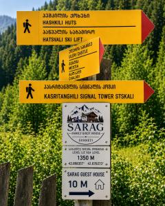 a group of signs on top of a mountain at Sarag Family Guesthouse Svaneti in Mestia