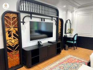 a living room with a tv and a entertainment center at Anara Sapa Hotel in Sapa