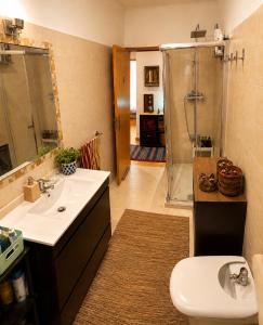 a bathroom with a sink and a shower and a toilet at Parque das Nações Room in Lisbon