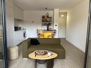 a living room with a couch and a table at Cozy apartment in Moliets-et-Maa