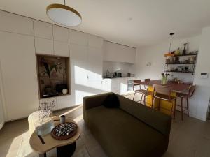 a living room with a couch and a table at Cozy apartment in Moliets-et-Maa