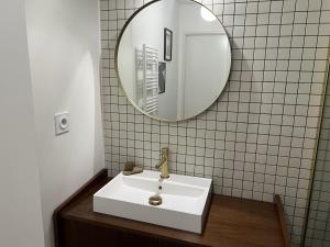 a bathroom with a white sink and a mirror at Cozy apartment in Moliets-et-Maa