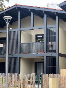 a house with a fence in front of it at Cozy apartment in Moliets-et-Maa +4 photos