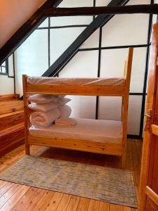 a room with a bunk bed in the attic at EarthShip Log Cabin, Timau in Nanyuki