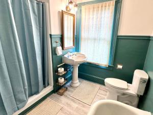 a bathroom with a sink and a toilet and a mirror at Camden at Monticello in Salisbury